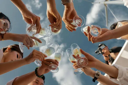 People standing in a circle raising a toast